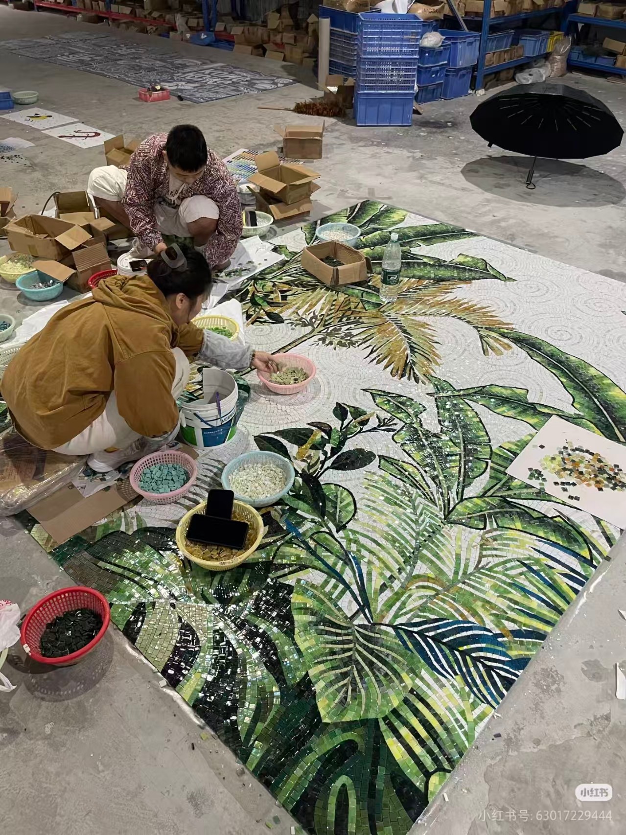 Craftsman assembling a geometric mosaic pattern by hand