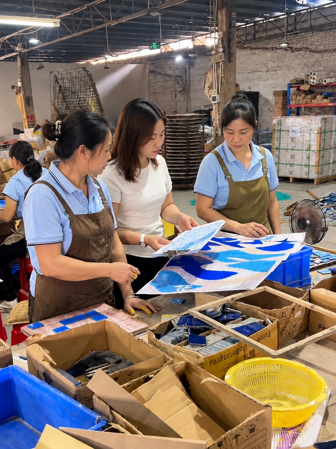 Quality inspection team reviewing blue and white mosaic materials in the workshop